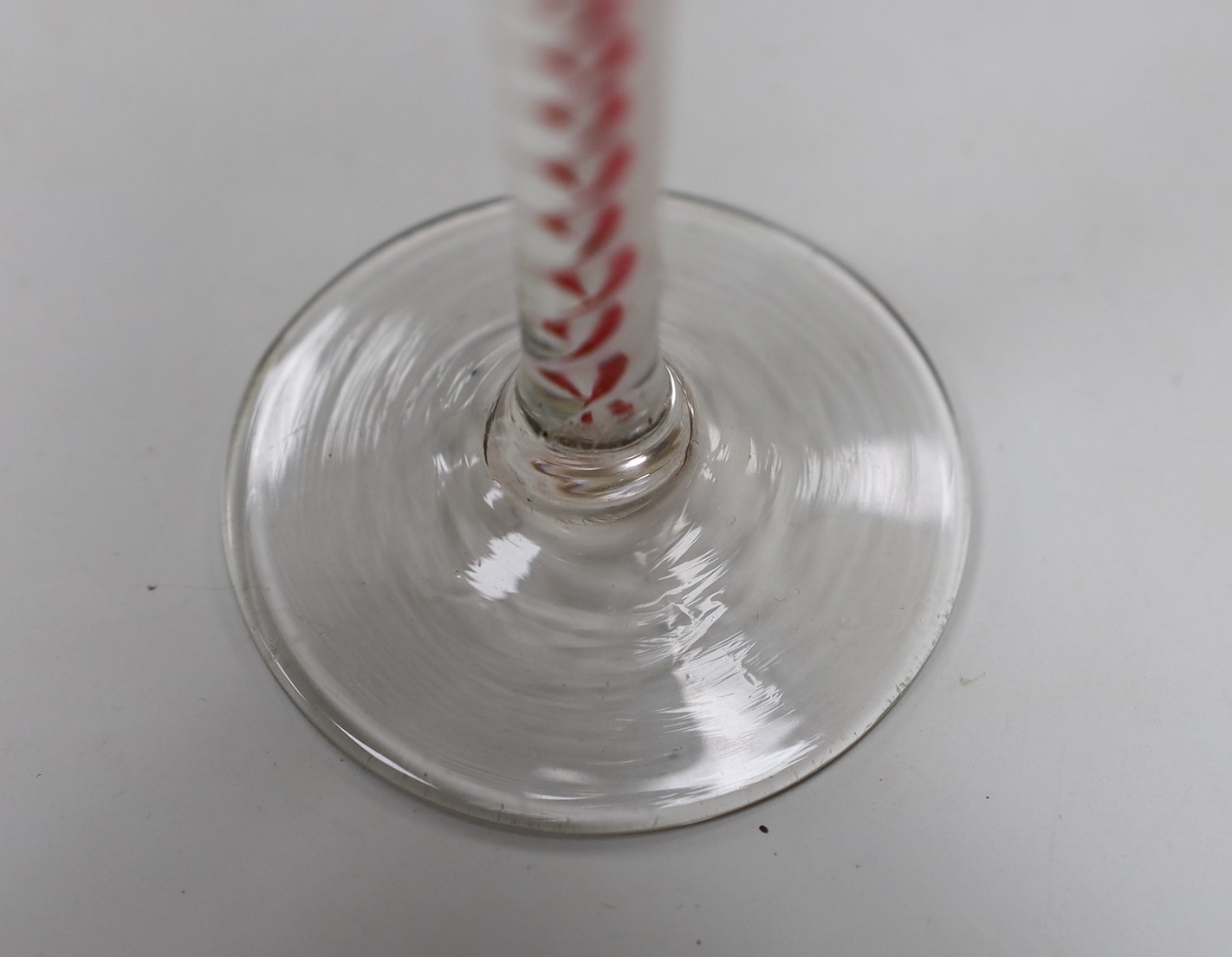A Dutch red and white colour twist stem cordial glass, 13cms high